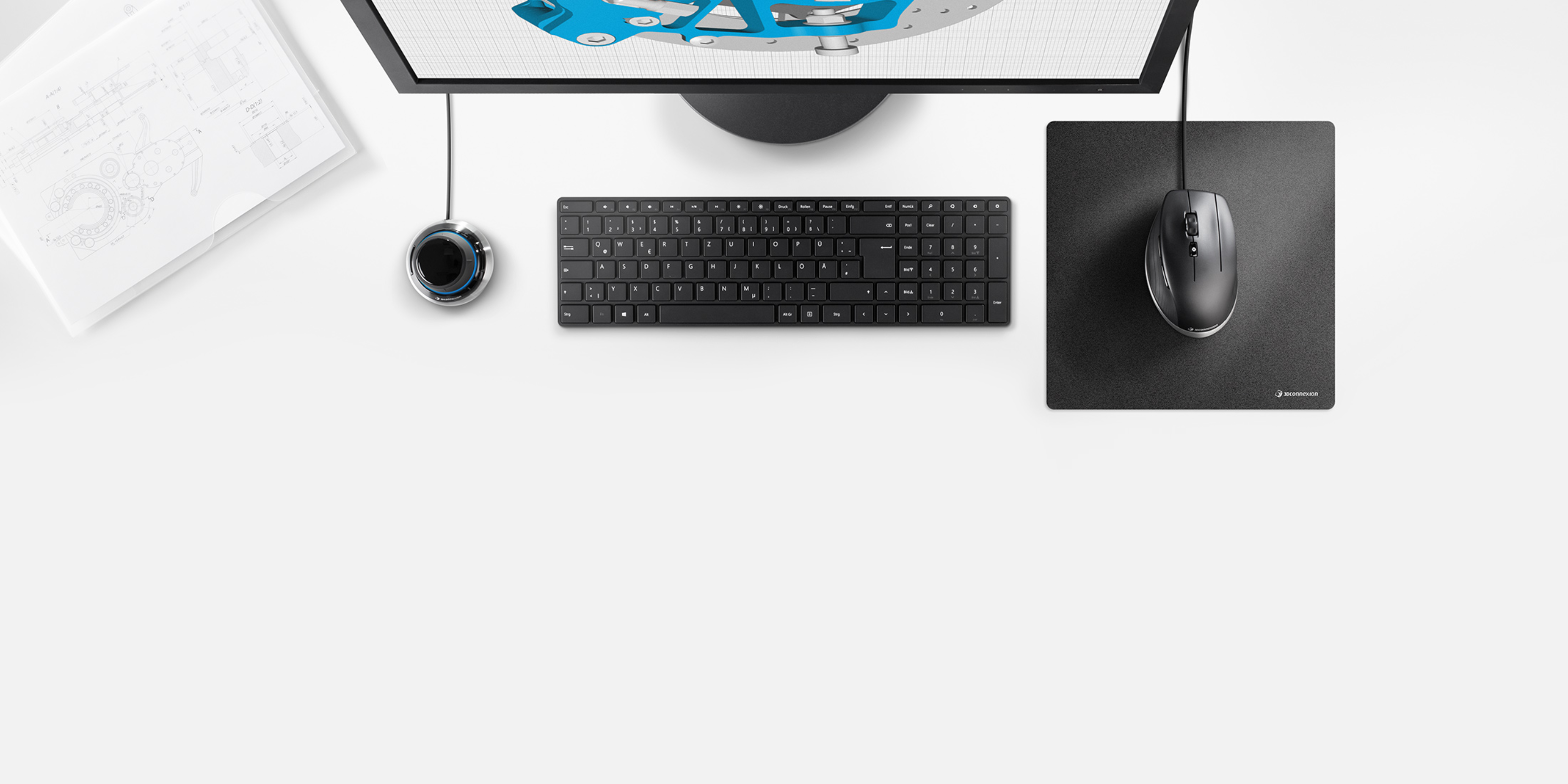 Top-down view of a 3D design workstation featuring a keyboard, mouse, and 3Dconnexion SpaceMouse® for immersive 3D navigation.