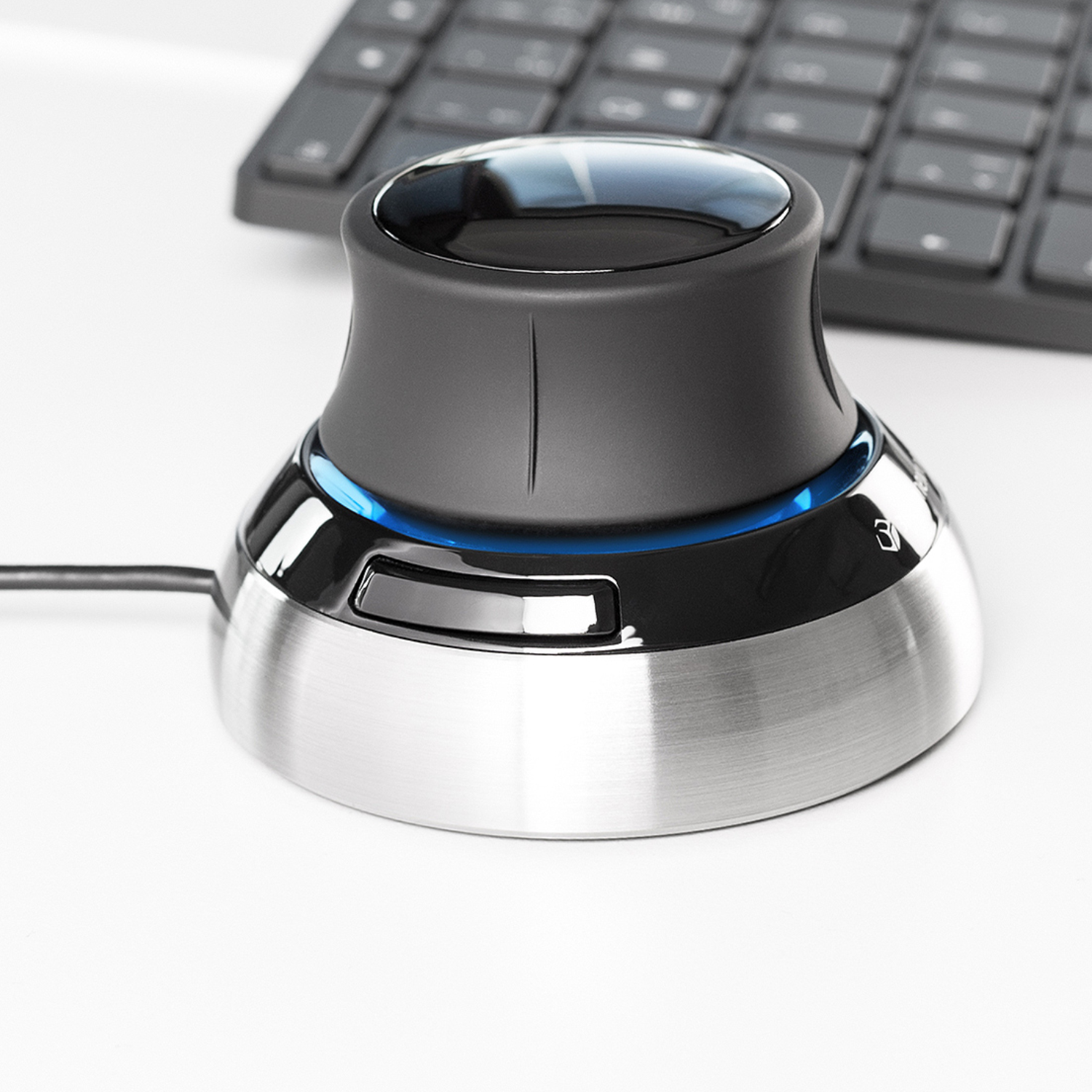 Close-up view of the 3Dconnexion SpaceMouse® Compact, highlighting its sleek design with a brushed metal base and ergonomic control knob.