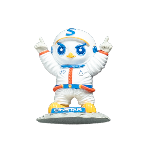 Colorful figurine of the Shining mascot in an astronaut suit, included in the packaging of the EINSTAR VEGA 3D Scanner.