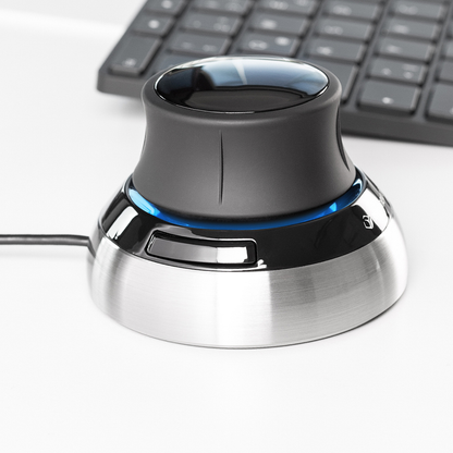 Close-up view of the 3Dconnexion SpaceMouse® Compact, highlighting its sleek design with a brushed metal base and ergonomic control knob.
